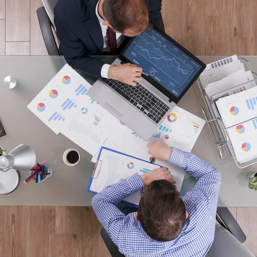 top-view-of-businessmen-analyzing-management-statistics-while-working-at-company-investments top-view-of-businessmen-analyzing-management-statistics-while-working-at-company-investments